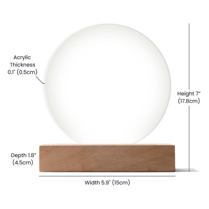 White spherical object on a wooden base with measurements indicated